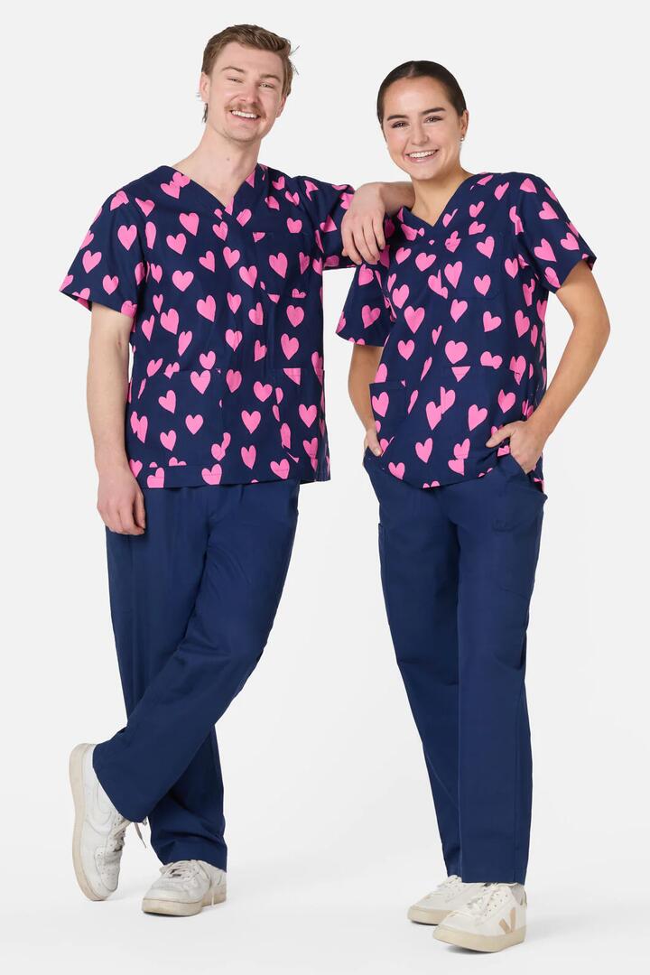 Image of a model wearing Uniforms & Workwear. Productname: Lovehearts Top & Pant Scrub Set in Navy colour by brand - Scrubs With Love