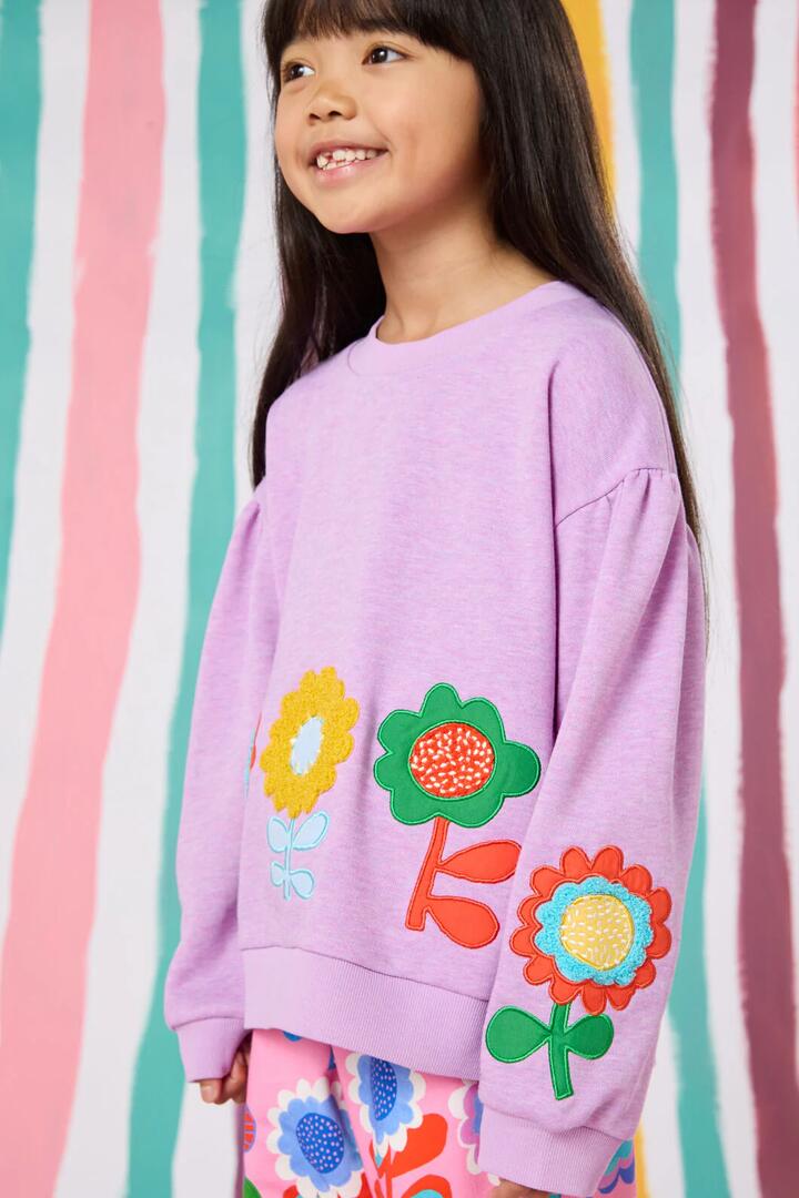Image of a model wearing Outerwear. Product name - Applique Floral Kids Sweater in Pink colour by brand - Gorman