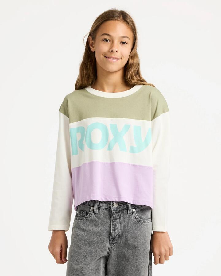 Image of a model wearing Tops. Product name - Roxy Girls 4-16 Sundaze Spirit Long Sleeve T-Shirt Coconut Milk in Coconut Milk colour by brand - Roxy
