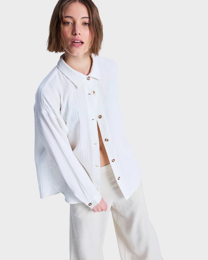 Image of a model wearing Tops. Productname: Roxy Womens Morning Shinte Stripe Long Sleeve Shirt Coconut Milk - in Coconut Milk colour by brand - Roxy