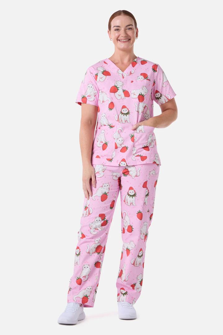 Image of a model wearing Uniforms & Workwear. Productname: Strawberry Cats Scrub Set in Pink colour by brand - Scrubs With Love