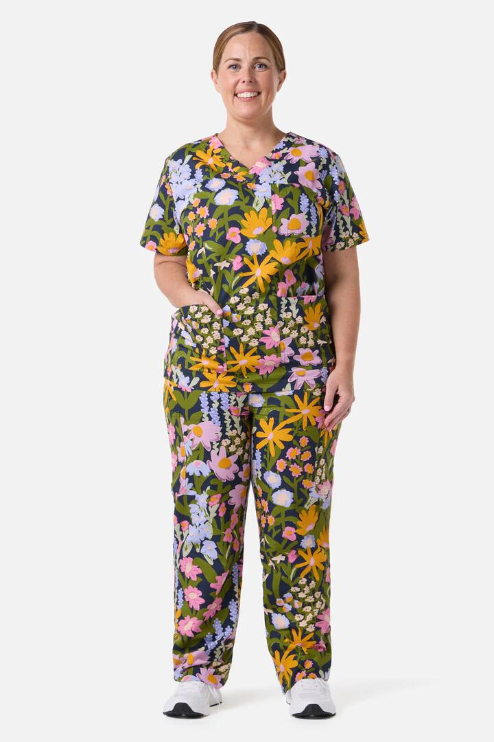 Image of a model wearing Uniforms & Workwear. Productname: Painted Garden Scrub Set in Navy colour by brand - Scrubs With Love
