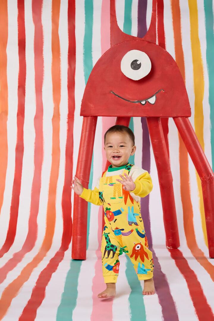 Image of a model wearing Pants. Product name - Monster Play Baby Overalls in Yellow colour by brand - Gorman