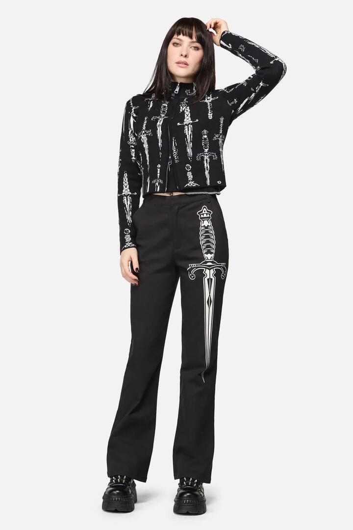 Image of a model wearing Pants. Productname: Dagger Goth Flare Pant in Black colour by brand - Dangerfield