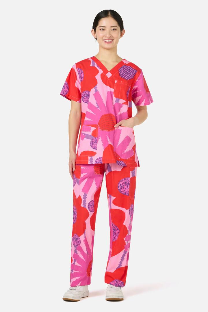 Image of a model wearing Uniforms & Workwear. Product name - Riso Floral Scrub Set in Pink colour by brand - Gorman
