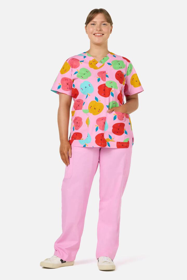 Image of a model wearing Uniforms & Workwear. Product name - She's Apples Top & Pant Scrub Set in Pink colour by brand - Gorman
