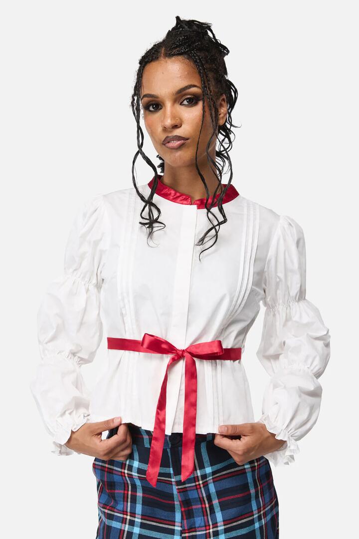 Image of a model wearing Tops. Productname: Dame Long Sleeve Ribbon Blouse in White colour by brand - Black Friday