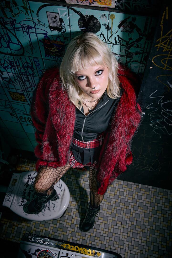 Image of a model wearing Outerwear. Productname: Louve Faux Fur Lined Coat in Red colour by brand - Black Friday