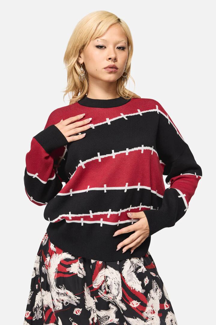 Image of a model wearing Outerwear. Productname: Louve Knitted Oversize Jumper in Red/Black colour by brand - Black Friday