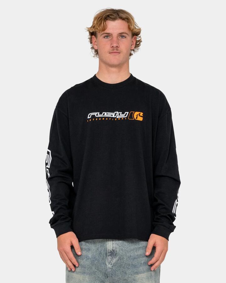 Image of a model wearing Tops. Product name - Rusty Mens Jetsetter Long Sleeve T-Shirt Black in Black colour by brand - Rusty