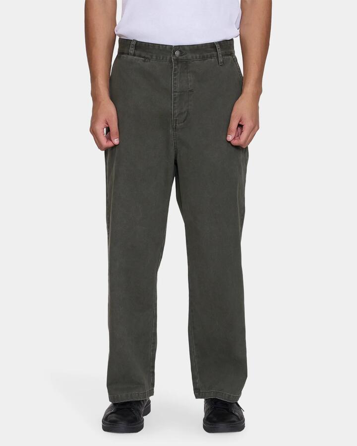 Image of a model wearing Pants. Product name - Thrills Mens Stagger Big Slacker Cropped Pants Oil Green in Oil Green colour by brand - Thrills