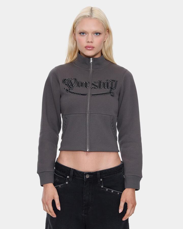 Image of a model wearing Outerwear. Product name - Worship Womens Treasured Y2K Zip Fleece Jacket Worn Black in Worn Black colour by brand - Worship