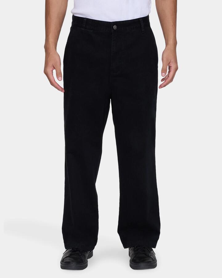 Image of a model wearing Pants. Product name - Thrills Mens Stagger Big Slacker Cropped Pants Black in Black colour by brand - Thrills