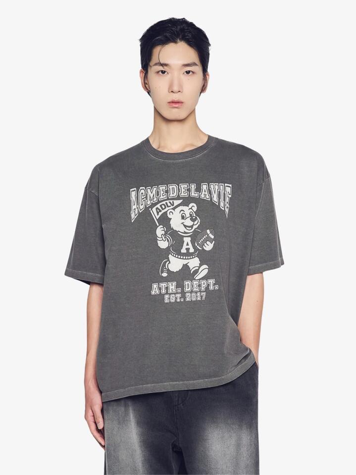Image of a model wearing Tops. Productname: ADLV Football Ac Bear Pigment Short Sleeve T-Shirt in Charcoal colour by brand - ADLV