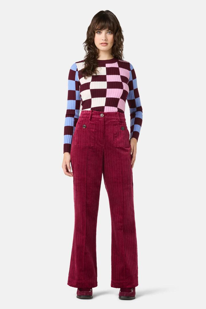 Image of a model wearing Pants. Product name - Pesto Chilli Cord Pant in Burgundy colour by brand - Gorman