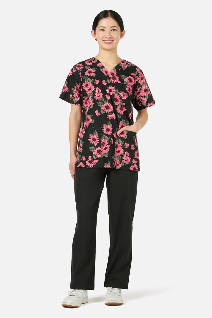 Image of a model wearing Uniforms & Workwear. Productname: Winter Daisy Top & Pant scrub set in Green colour by brand - Scrubs With Love