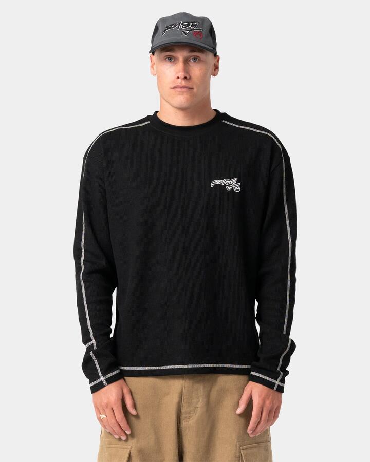 Image of a model wearing Tops. Product name - Rusty Mens Chuck No Worries Long Sleeve T-Shirt Black in Black colour by brand - Rusty