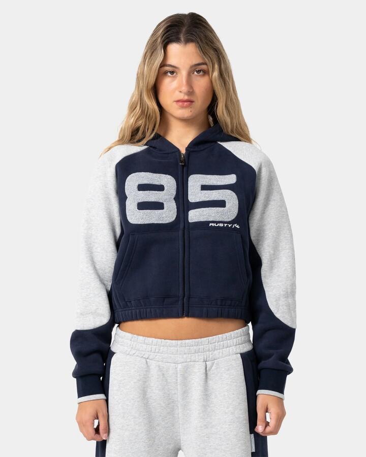 Image of a model wearing Outerwear. Product name - Rusty Womens Harvest Cropped Zip Up Hoodie Navy in Navy colour by brand - Rusty