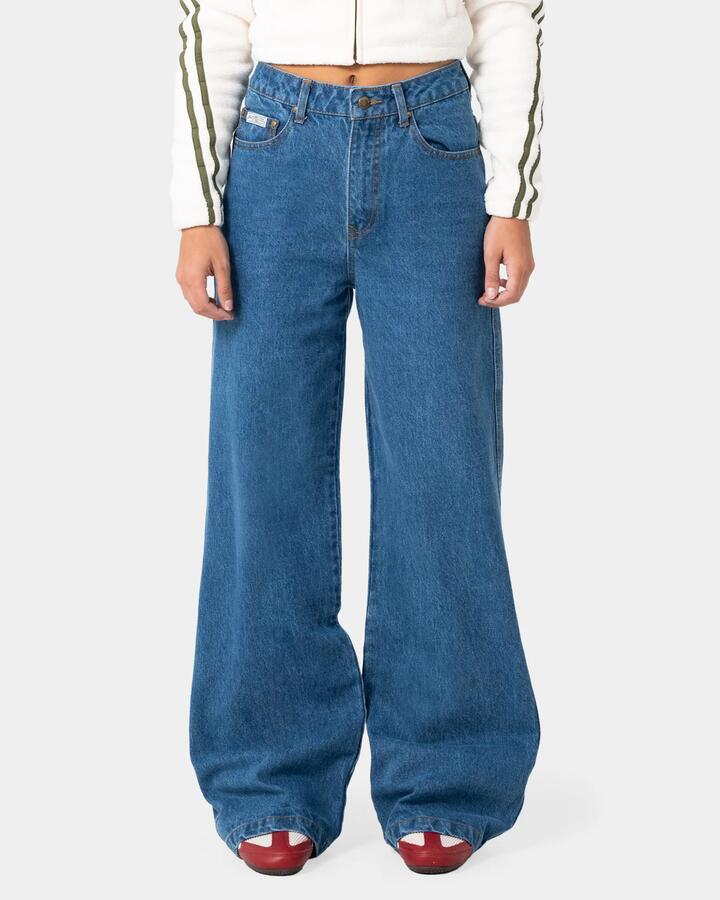 Image of a model wearing Pants. Product name - Rusty Womens Cyprus Wide Leg High Waist Denim Jeans Authentic Blue in Authentic Blue colour by brand - Rusty
