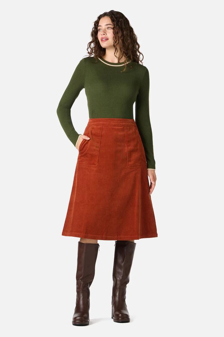 Image of a model wearing Skirts. Product name - Jamie Cord Midi Skirt in Rust colour by brand - Princess Highway