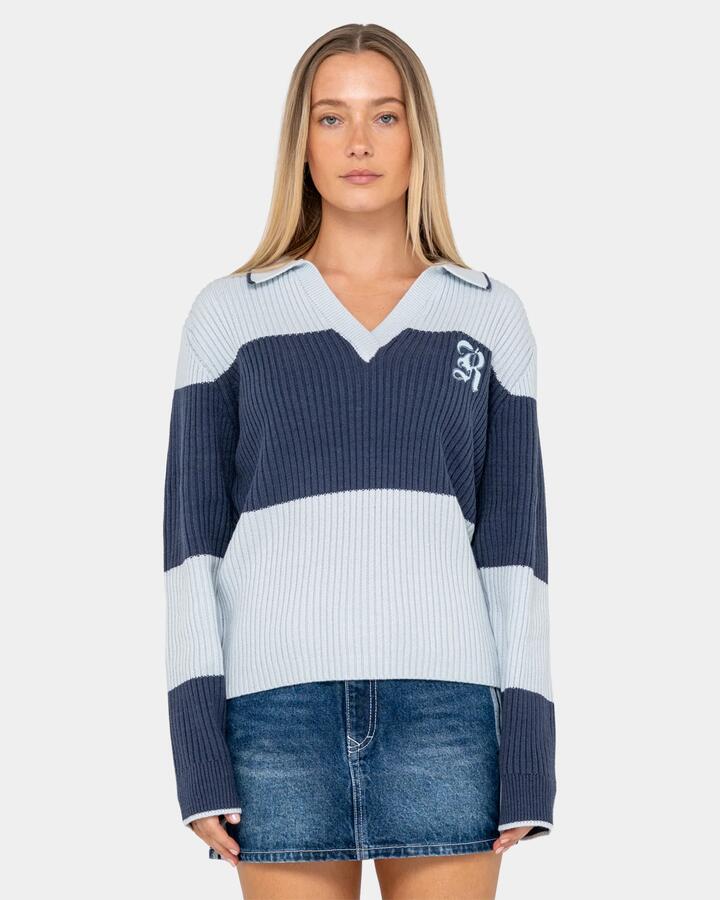 Image of a model wearing Tops. Product name - Rusty Womens Try Me Knitted Long Sleeve Rugby Shirt Retro Blue / Navy in Retro Blue / Navy colour by brand - Rusty