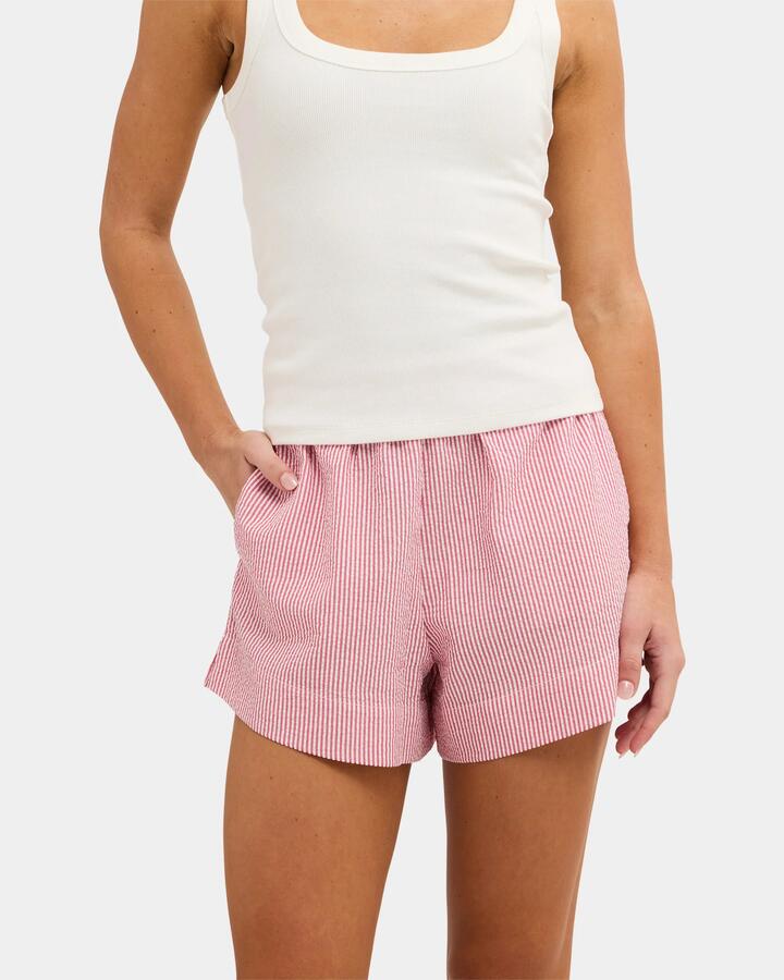 Image of a model wearing Shorts. Product name - Nunui Womens Wilderness Stripe Elastic Waist Shorts Red in Red colour by brand - Nunui