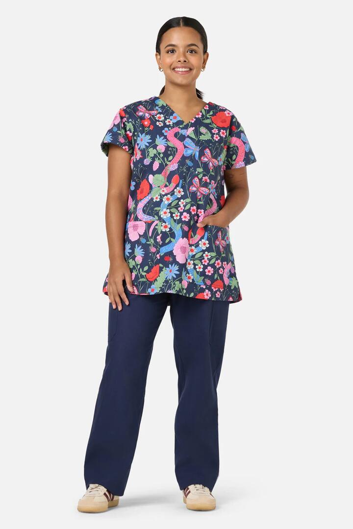 Image of a model wearing Uniforms & Workwear. Productname: Snakes & Flora Top & Pant Scrubs in Navy colour by brand - Scrubs With Love