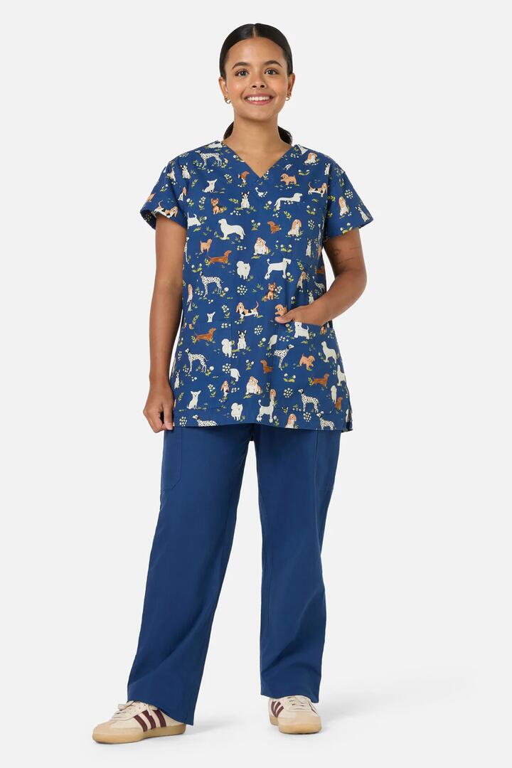 Image of a model wearing Uniforms & Workwear. Productname: Cute Dogs Top & Pant Scrub Set in Navy colour by brand - Scrubs With Love