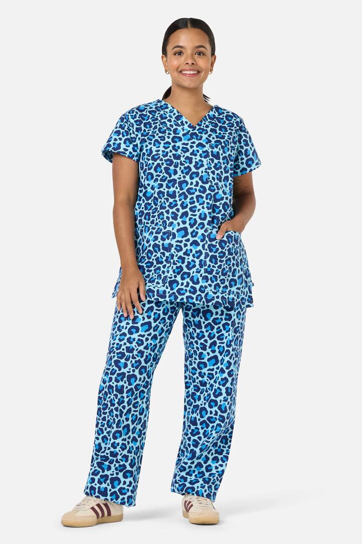 Image of a model wearing Uniforms & Workwear. Productname: Leopard Cub Scrub Set in Blue colour by brand - Scrubs With Love
