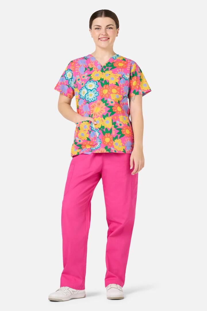 Image of a model wearing Uniforms & Workwear. Product name - Dream Garden Top & Pant Scrubs in Pink colour by brand - Gorman