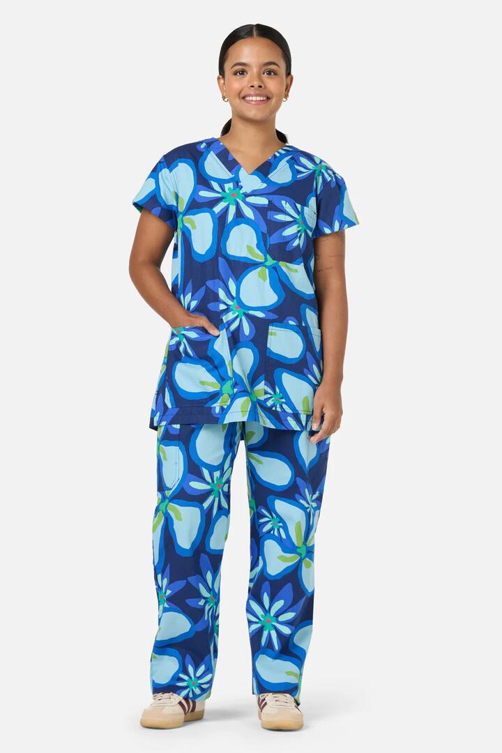 Image of a model wearing Uniforms & Workwear. Product name - Florita Scrub Set in Navy colour by brand - Gorman