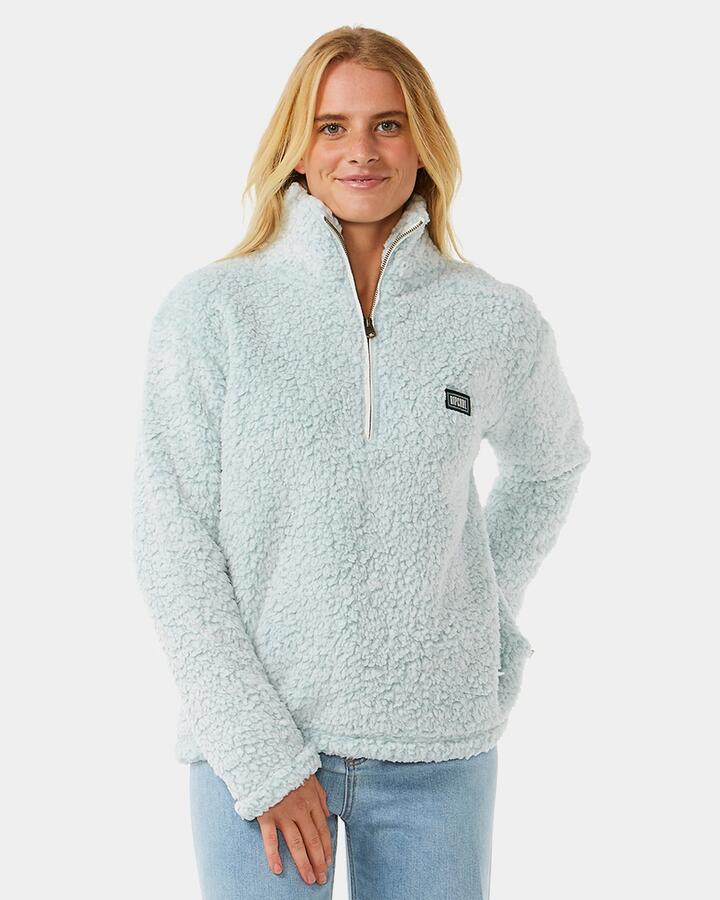 Image of a model wearing Outerwear. Product name - Rip Curl Womens Dark N Stormy 1/4 Zip Fleece Jumper Blue in Blue colour by brand - Rip Curl