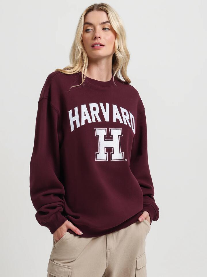 Image of a model wearing Outerwear. Productname: Ncaa Harvard University Crew Fleece in Wine colour by brand - Ncaa