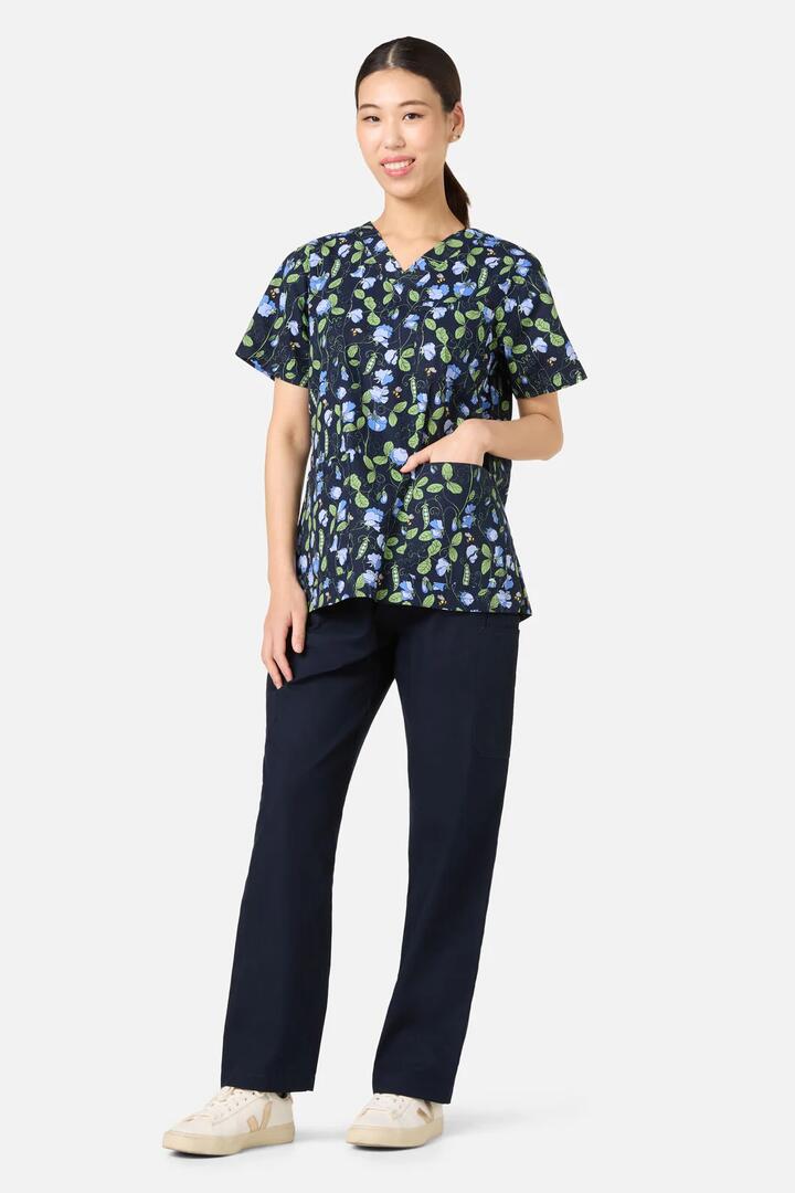 Image of a model wearing Uniforms & Workwear. Productname: Sweet Pea Top & Pant Scrub Set in Navy colour by brand - Scrubs With Love