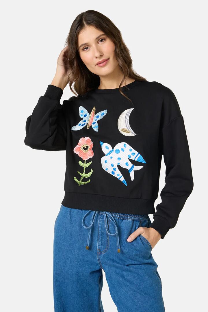 Image of a model wearing Outerwear. Product name - The Garden Embroidered Sweater in Black colour by brand - Gorman