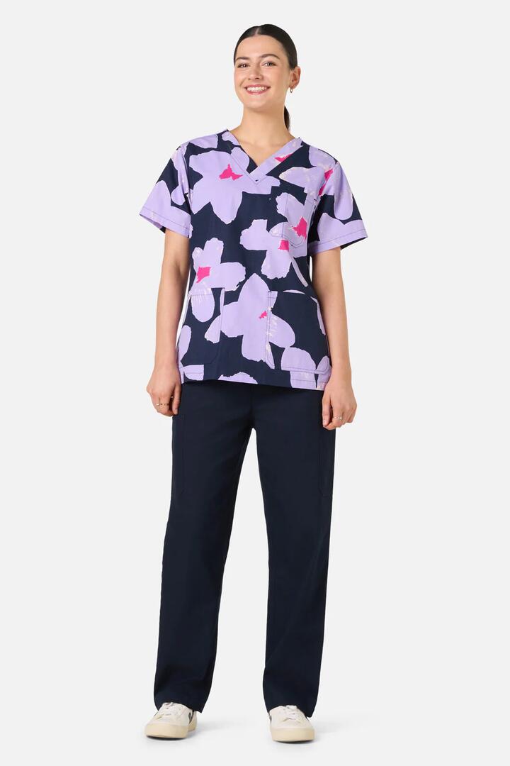 Image of a model wearing Uniforms & Workwear. Product name - Poppy Blue Top & Pant Scrub Set in Navy colour by brand - Gorman