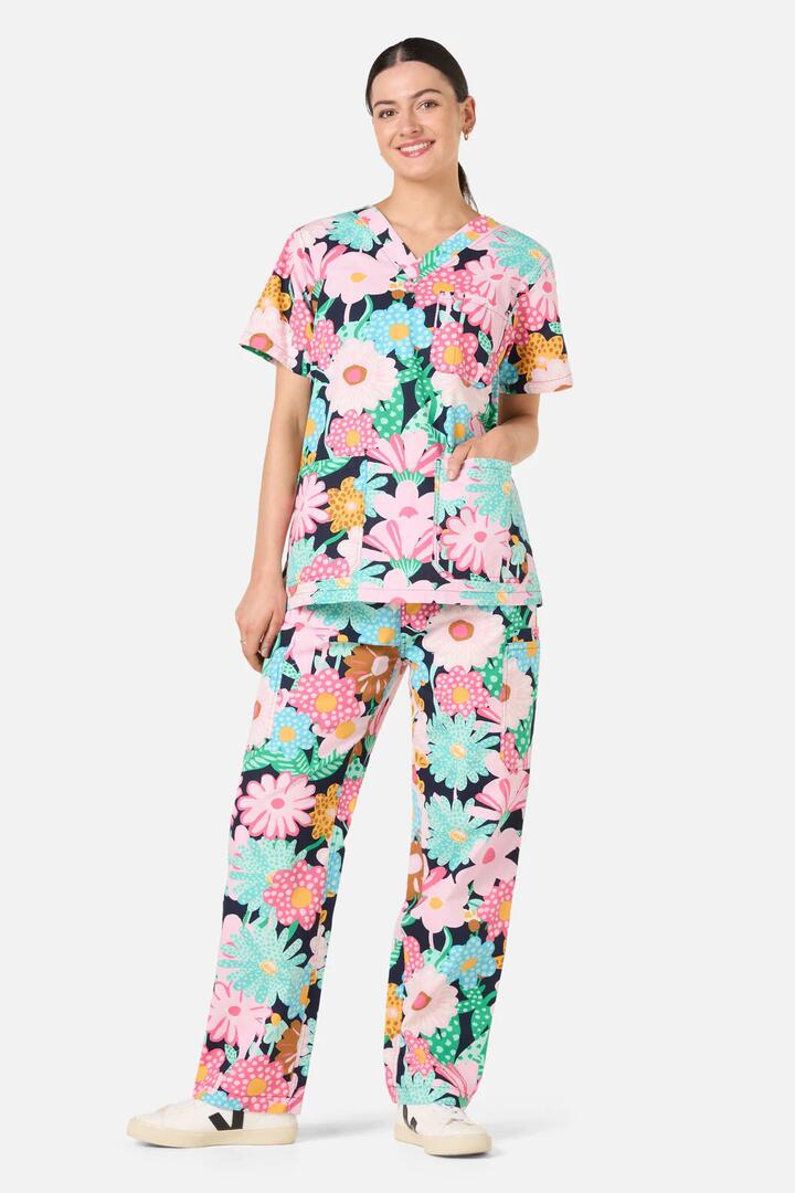 Image of a model wearing Uniforms & Workwear. Product name - Magic Floral Scrub Set in Navy colour by brand - Gorman