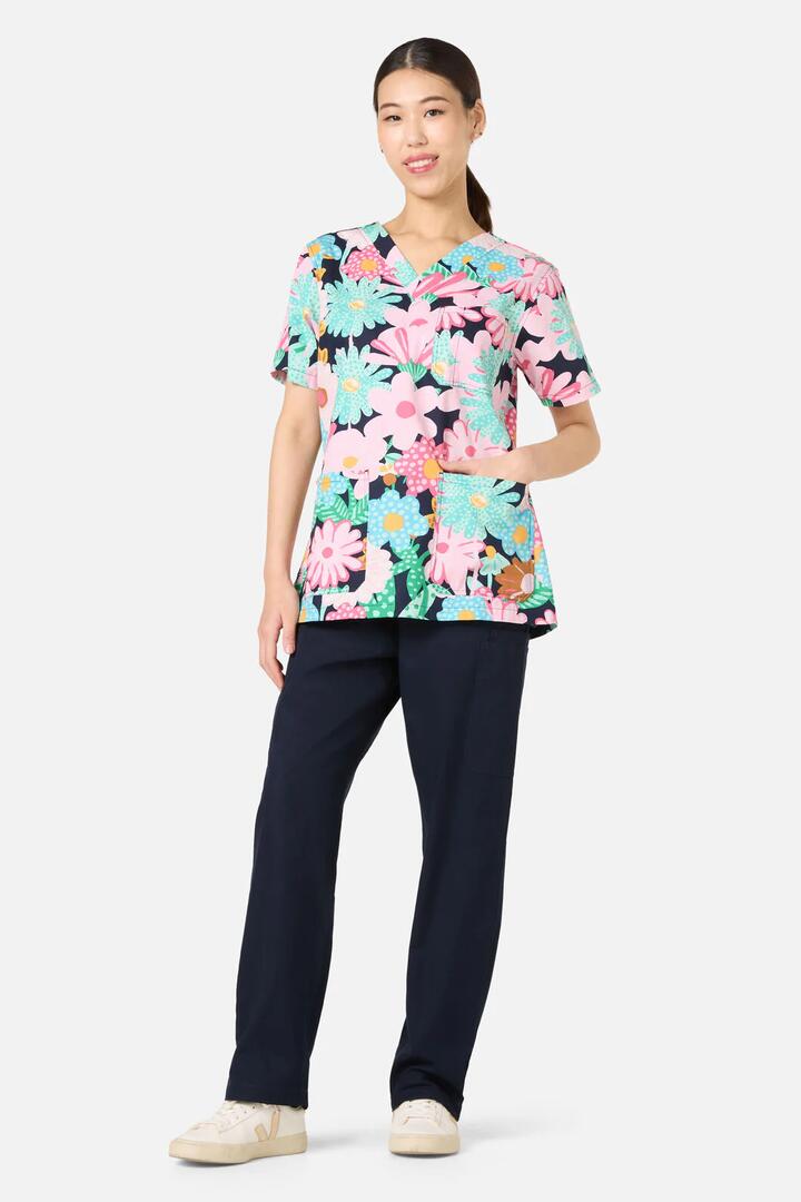 Image of a model wearing Uniforms & Workwear. Product name - Magic Floral Top & Pant Scrubs in Navy colour by brand - Gorman
