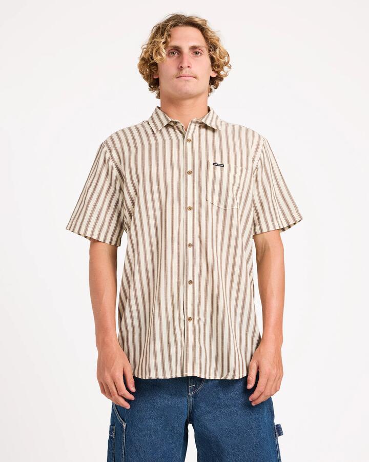 Image of a model wearing Tops. Product name - Volcom Mens Arvostripe Woven Short Sleeve Shirt Dark Earth in Dark Earth colour by brand - Volcom