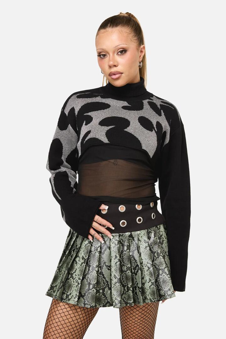 Image of a model wearing Tops. Productname: Y2K Sigil Turtleneck Crop Knit in Black colour by brand - Dangerfield