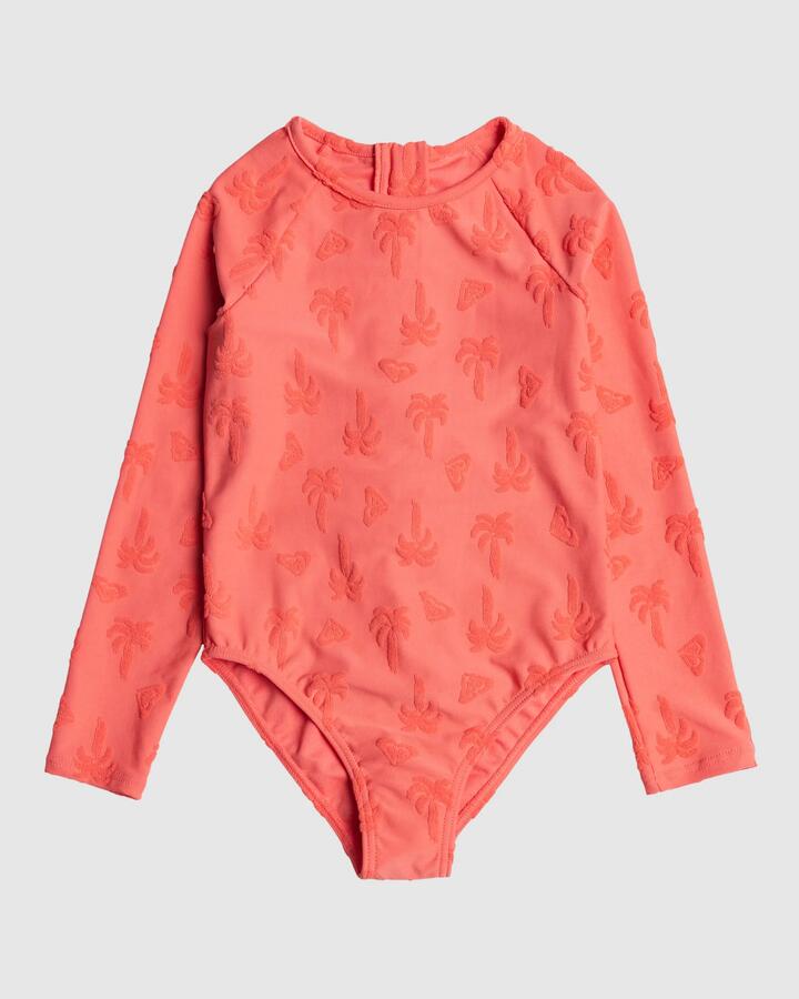 Image of a model wearing Tops. Product name - Roxy Girls 2-7 Palm Tree Long Sleeve Rash Vest Dubarry Palm Tree Please in Dubarry Palm Tree Please colour by brand - Roxy