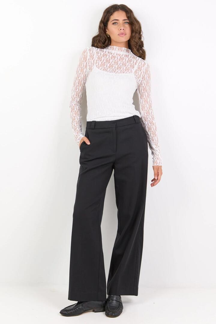 Image of a model wearing Pants. Product name - Jaunty Black Slant Pocket Wide Leg Pants in Black colour by brand - Among the Brave