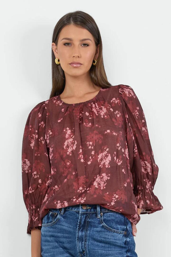 Image of a model wearing Tops. Product name - Candid Plum Smudge Floral Frill Sleeve Crew Neck Top in Plum Smudge Floral colour by brand - Ivy + Jack
