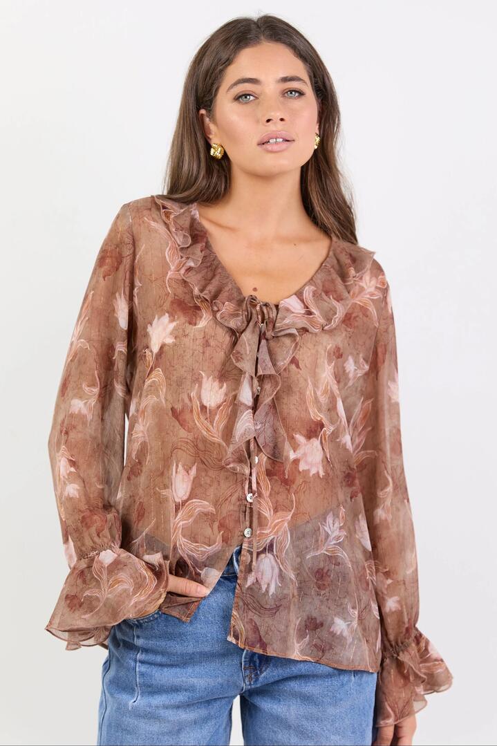 Image of a model wearing Tops. Product name - Bohemian Ochre Floral Black Trim Sheer Frill Front Blouse in Ochre Floral colour by brand - Among the Brave