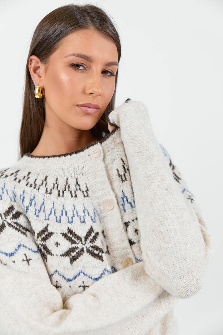 Image of a model wearing Outerwear. Product name - Shetland Oat Marle Fairisle Detail Cardigan in Oat Marle colour by brand - Among the Brave