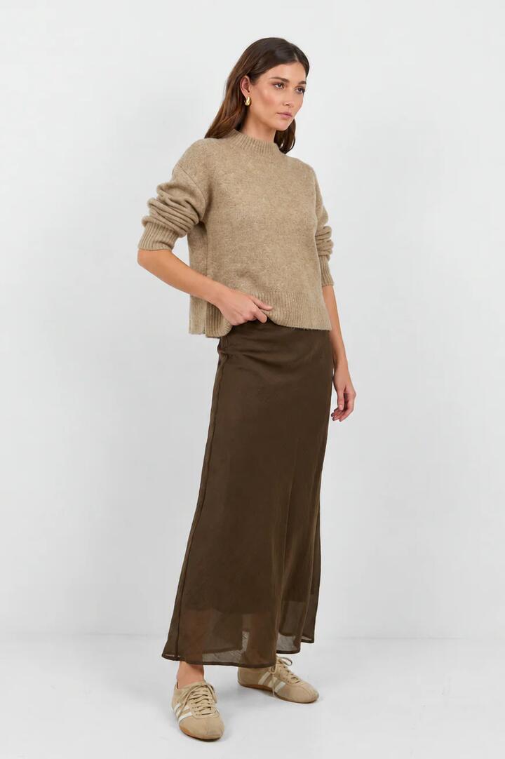 Image of a model wearing Skirts. Product name - Sahara Chocolate Luxe Linen Blend Bias Maxi Skirt in Chocolate colour by brand - Stories be Told