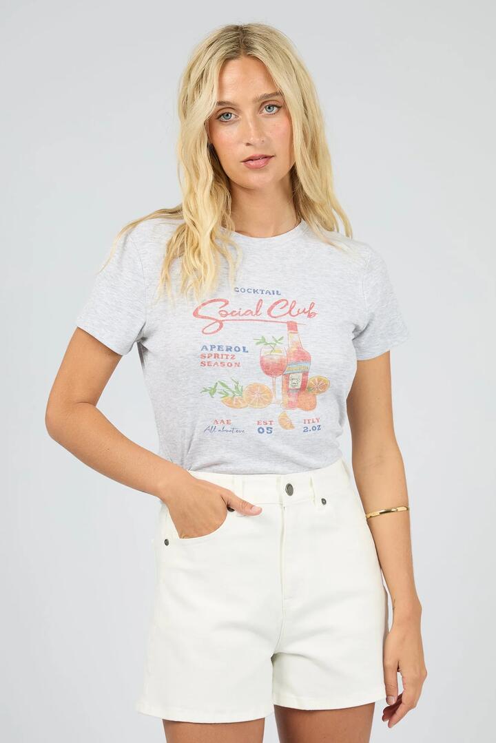 Image of a model wearing Tops. Product name - Social Club Snow Marle Cocktail Print Baby Tee in Snow colour by brand - All About Eve