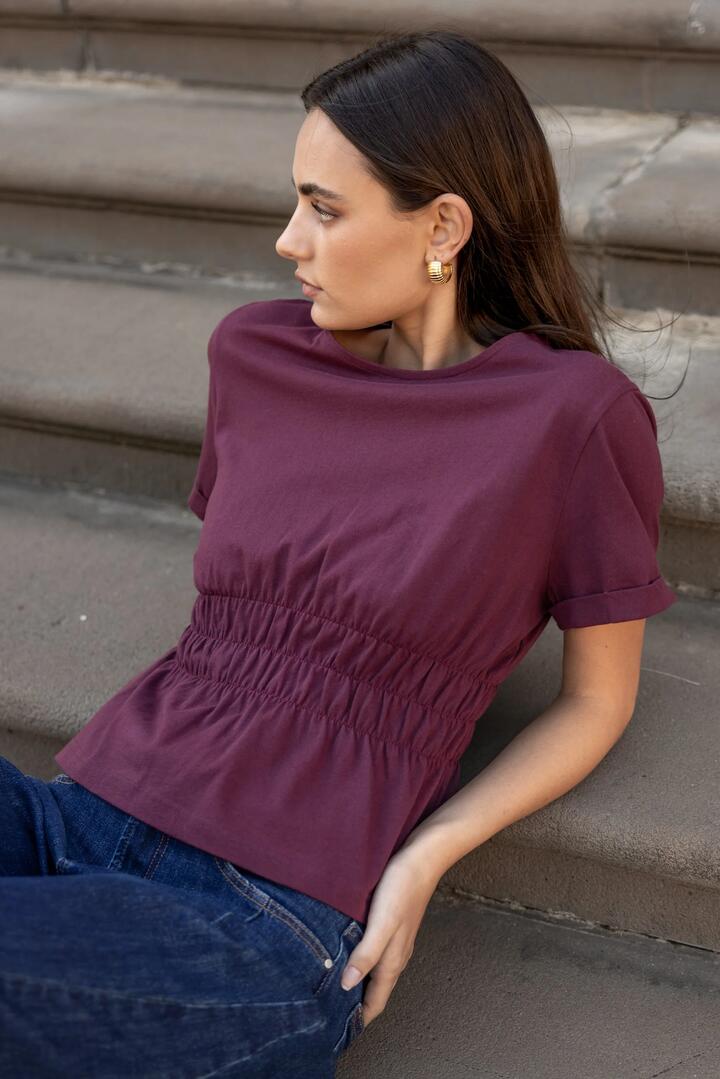 Image of a model wearing Tops. Product name - Svelte Burgundy Shirred Detail SS Tee in Burgundy colour by brand - Among the Brave