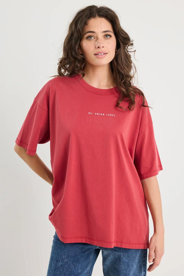 Image of a model wearing Tops. Product name - Novel Paprika Cotton Re:Union Oversized Tee in Paprika colour by brand - RE:UNION Label