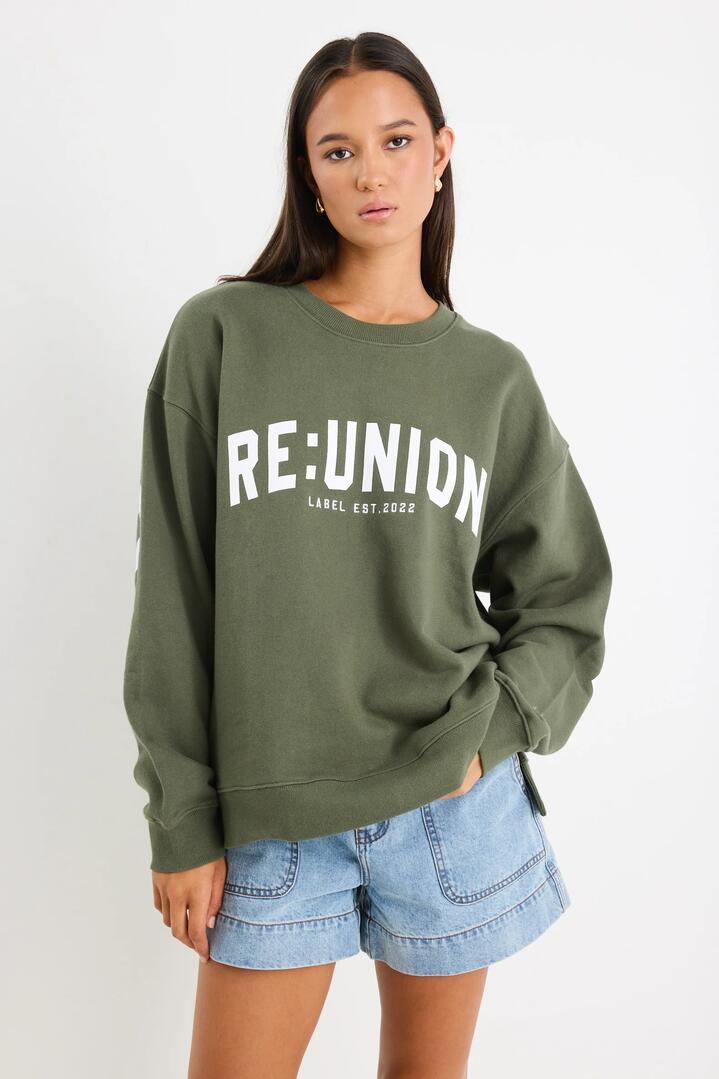 Image of a model wearing Outerwear. Product name - Myth Khaki Re:Union Sweatshirt in Khaki colour by brand - RE:UNION Label